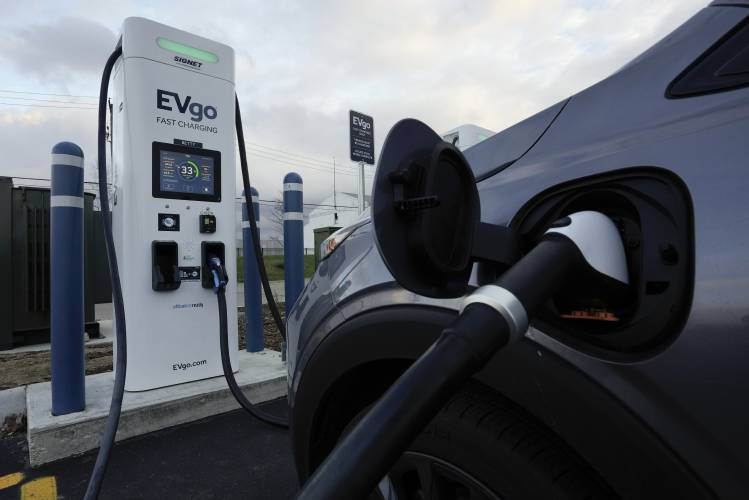An electric vehicle charges at an EVgo fast charging station in Detroit on Nov. 16, 2022.