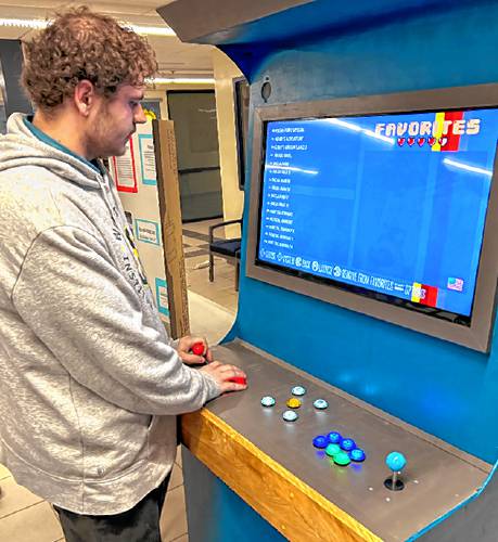 Merrimack Valley High School senior Clayton Ross demonstrates how to play the arcade he built for his senior project.