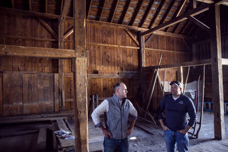Cedar Mill Group project managers Nick Colarusso (center) and Nick Domenici on the first floor of the red barn the company purchased on Tuesday, April 9, 2024. The fact the barn had a solid roof that kept the rain out of the structure, the barn is solid shape.