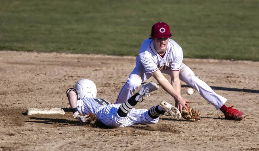 Concord shortstop Alex Turant tries to tag Manchester Central/West second baseman Gavin Currier on Monday afternoon, April 15, 2024. Concord lost in extra innings, 15-10.
