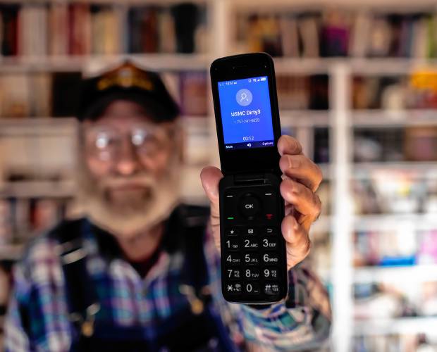 Denis O’Connell dials the Camp Lejeune number at his home in Concord earlier this month. O’Connell served in the Marines and was stationed at the giant military base where Marines and sailors train and operate.