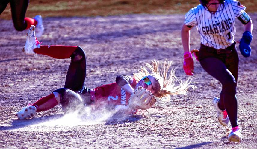 Coe-Brown shortstop Annie Jerome falls to the ground as she snags the last out against Pembroke on Tuesday. The game ended after the fifth inning after the 10-run rule as the Bears won, 15-2. Coe-Brown has won five in a row and has scored 13 or more runs in its last three games.