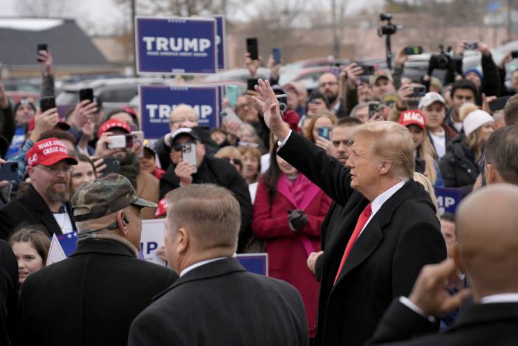 Republican presidential candidate former President Donald Trump waves to supporters as he arrives at a campaign stop in Londonderry, N.H., Tuesday, Jan. 23, 2024. (AP Photo/Matt Rourke)