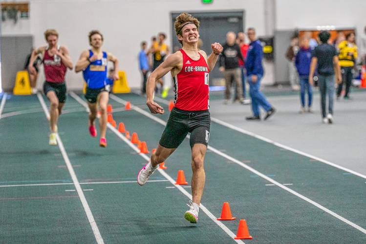 Coe-Brown’s Jamie Lano pumps his fist in celebration as he crosses the line to win the 1,500-meter title at the NHIAA Division II indoor track & field championships on Sunday at Plymouth State. Lano also won the 3,000 and finished second in the 1,000 to lead Coe-Brown to back-to-back team titles.