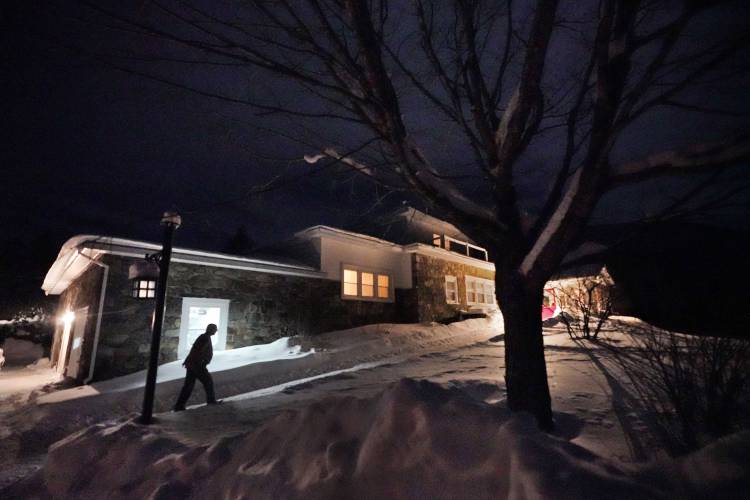 A man arrives Monday evening, Jan. 22, 2024, at the Tillotson House where six voters in the hamlet of Dixville Notch, N.H. will cast their ballots at midnight in the presidential primary election. (AP Photo/Robert F. Bukaty)